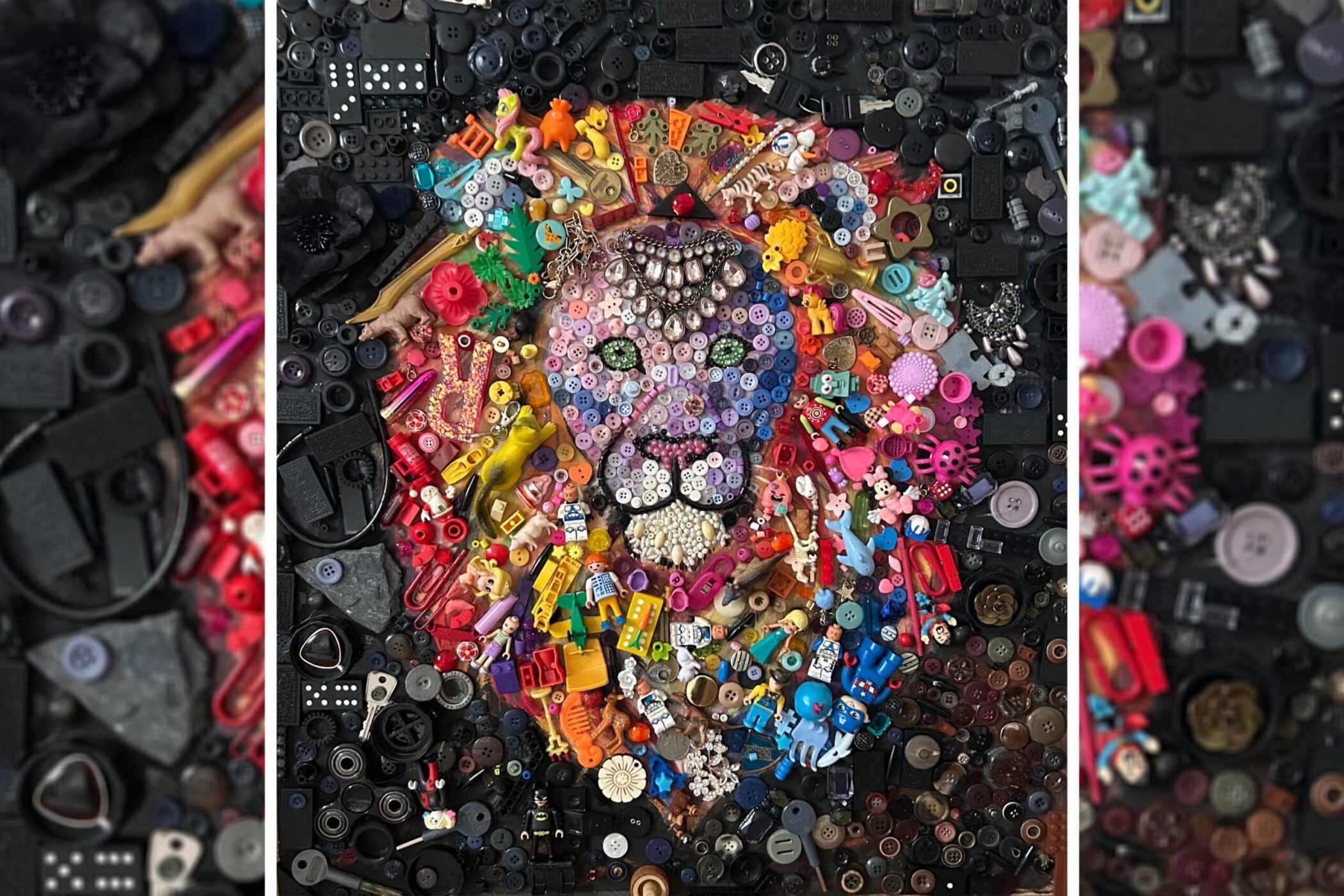 Feeling creative? A lion’s face is crafted using colourful objects like buttons, toy blocks, and plastic items, all arranged on a dark background of black buttons and assorted pieces.