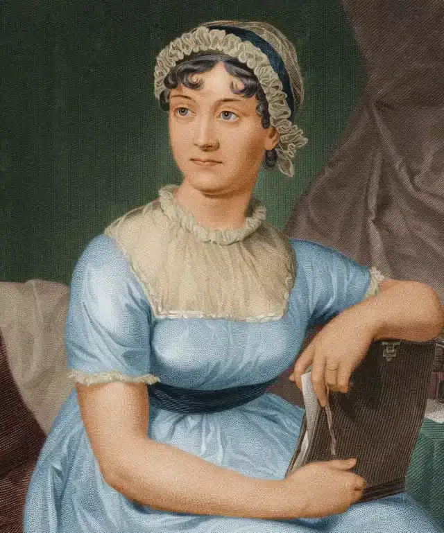 A woman in a blue dress and bonnet sits holding an open book. She gazes thoughtfully to the side, with a slight smile. The background features draped fabric and a table with an inkstand and papers.