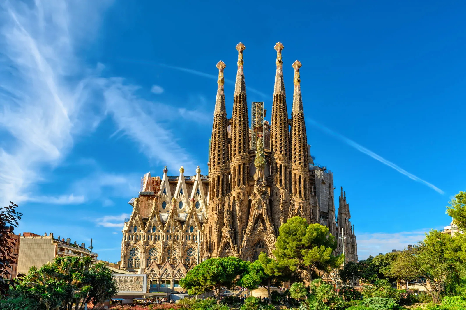 The Sagrada Família basilica in Barcelona under a clear blue sky.